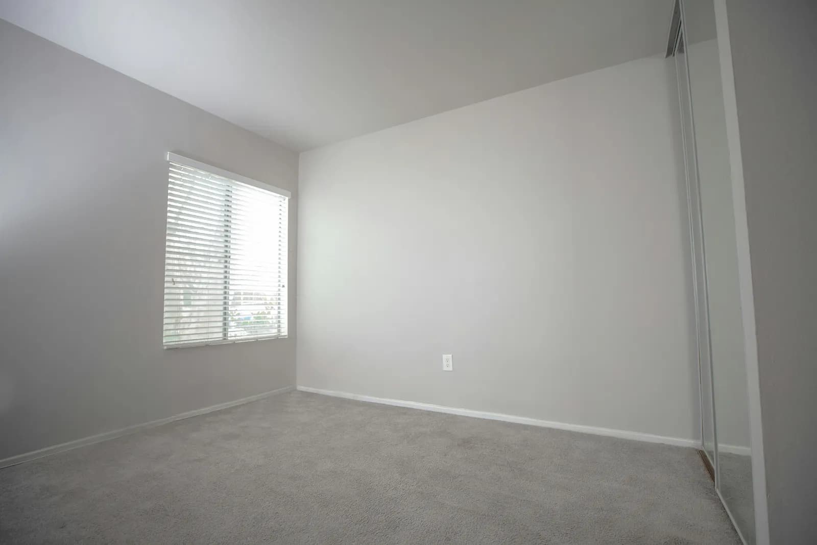 An empty bedroom photographed on an iPhone