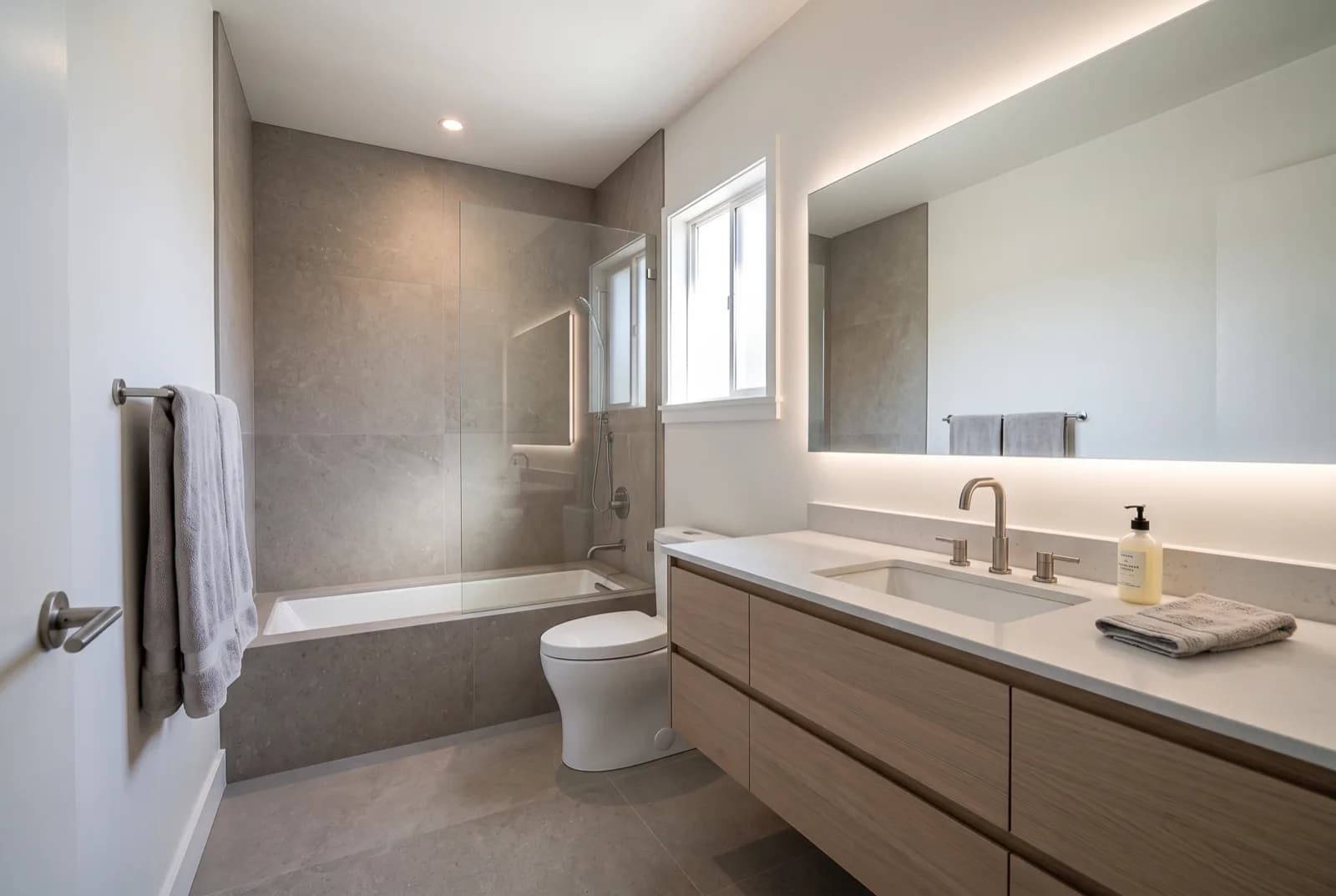 AI-generated sample redesign: Same bathroom redesigned in minimalist style: large-format stone tile, floating vanity and glass shower