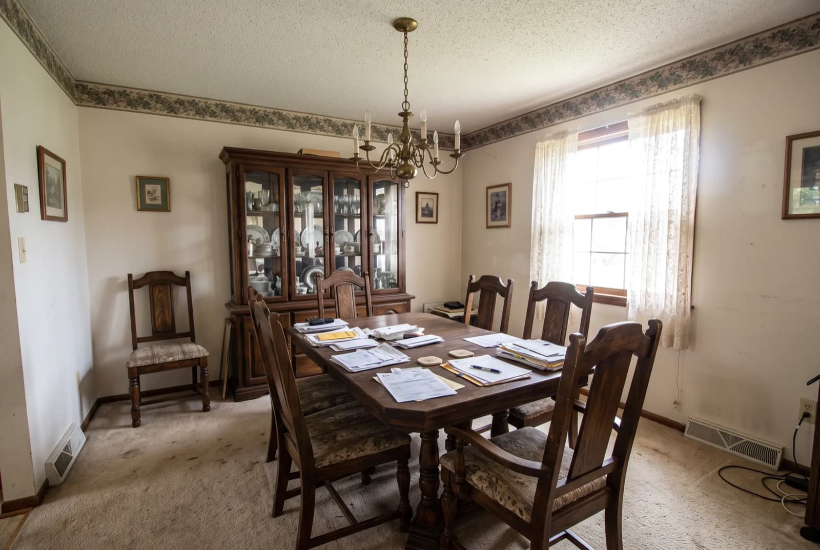 AI-generated sample redesign: Same dining room redesigned in Mediterranean style: limewashed walls, terracotta floor and rustic wood table, before