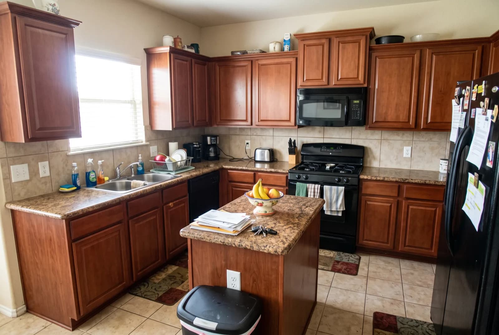 AI-generated sample redesign: Same kitchen redesigned in modern style: flat-panel cabinets, black counters and under-cabinet lighting, before